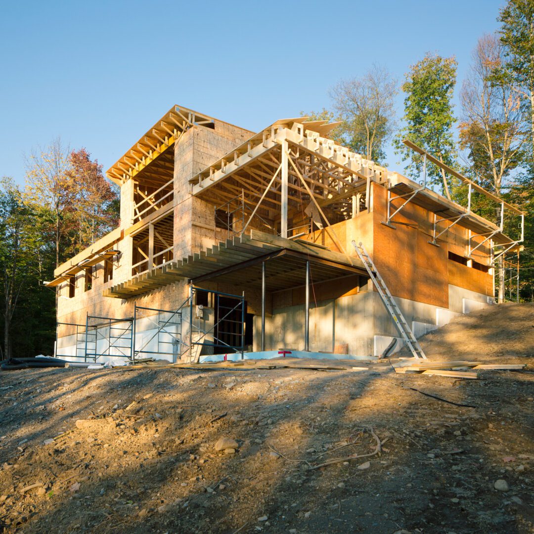 House under construction in forest setting